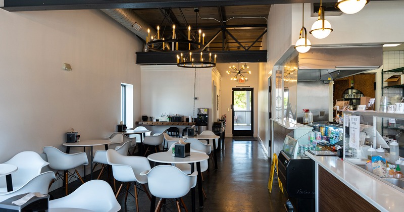 Interior, white tables and white plastic arm chairs, order counter