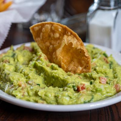 Guacamole topped with a tortilla chip.