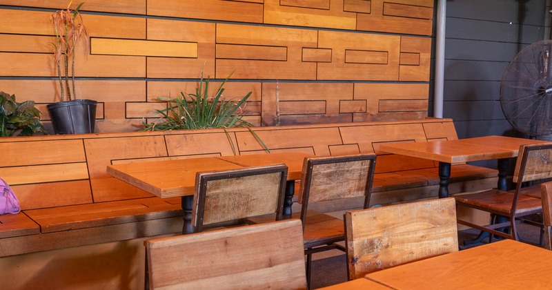 Outdoor seating area with wooden furniture and a TV