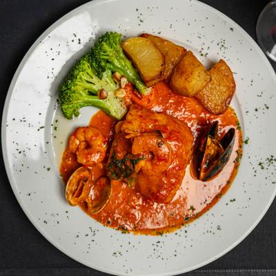 Mixed seafood in light red sauce.