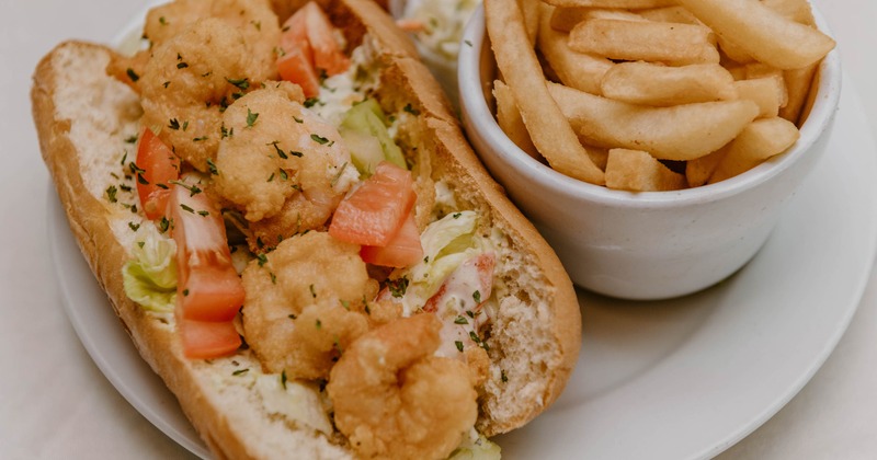 Shrimp po boy served with fries and coleslaw