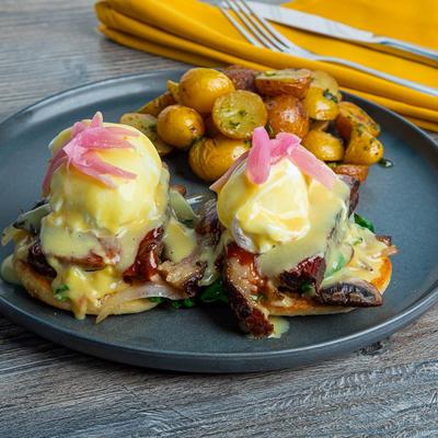 Smoked BBQ Brisket benedict with roasted baby potatoes on the side.