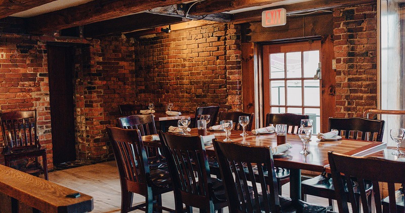 Interior, guests tables with tableware and wine glasses