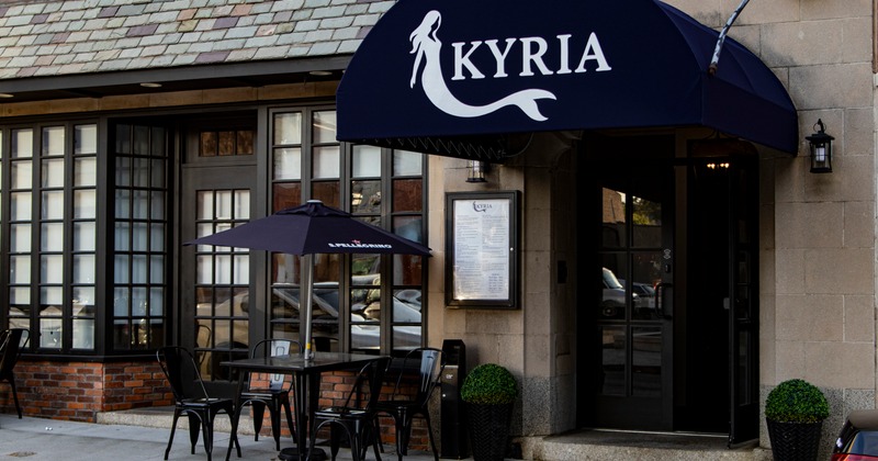 Dimly lit dining room with elegantly set tables and warm lighting