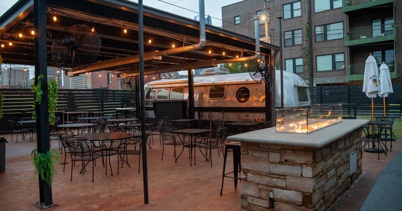 Outdoor patio with metal seating, a fire pit in front