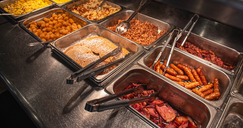 A breakfast buffet setup with various dishes