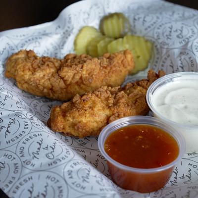 Golden-brown fried chicken tenders with crinkle-cut pickles & two dipping sauces..