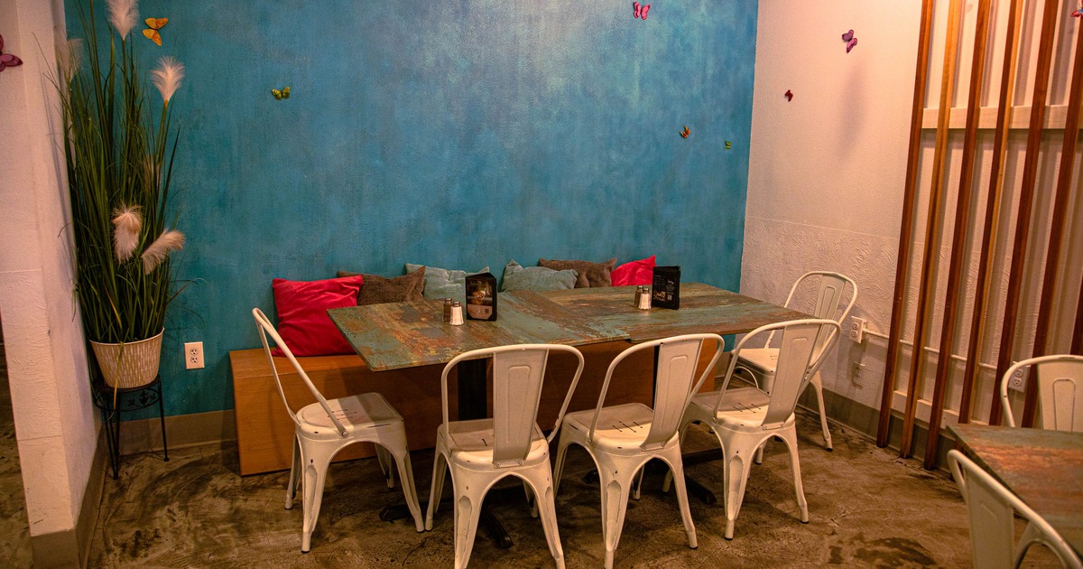 Dining tables with chairs, and seats with pillows