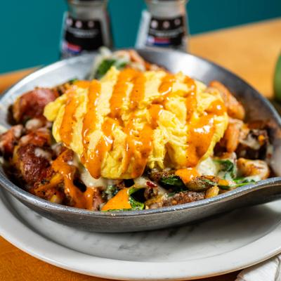 Breakfast skillet with eggs and vegetables.