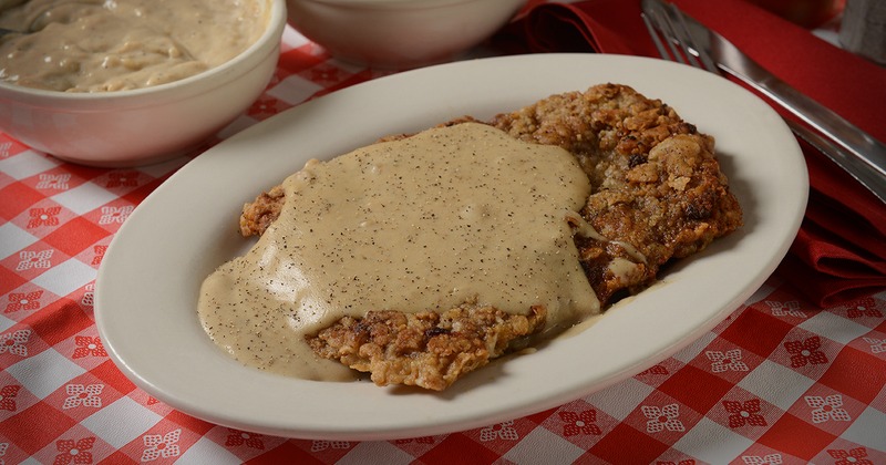 Chicken fried steak topped with a peppery white country gravy