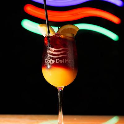 Layered cocktail with citrus garnish.