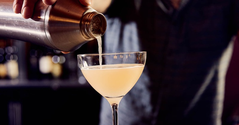 A hand pouring a beverage