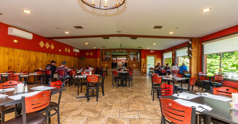 Interior, dining area with set tables, guests enjoying their food and drinks