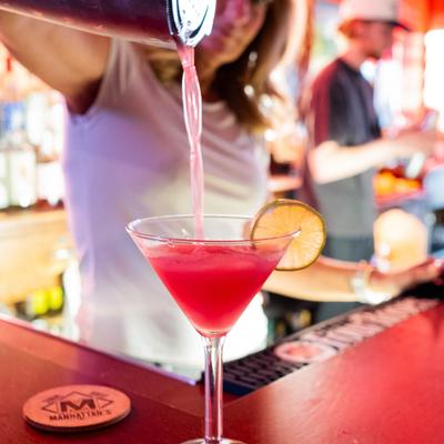 Bartender pouring a cocktail.