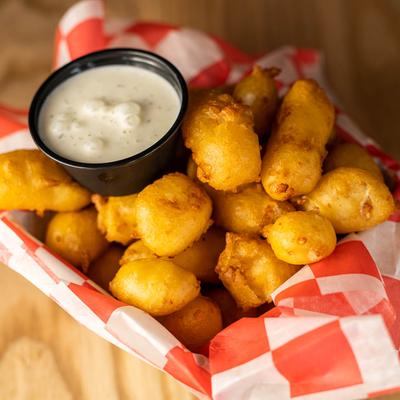 Cheese curds with a dipping sauce.