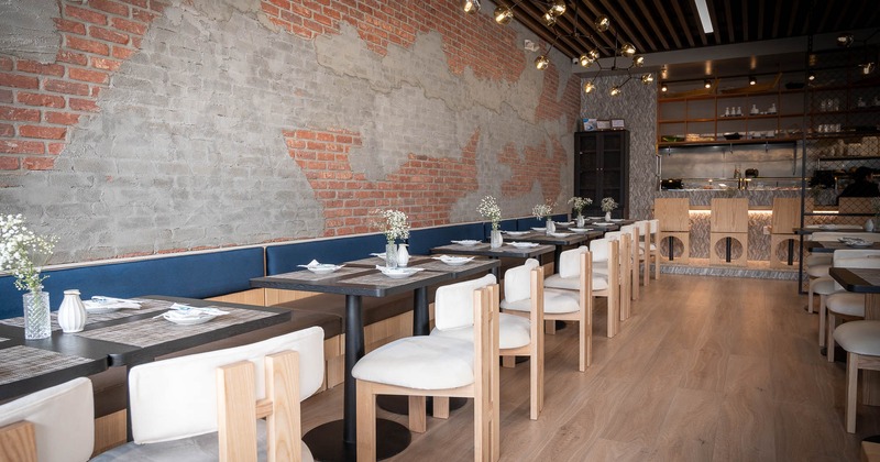 Interior, bench seating by the wall, tables and chairs