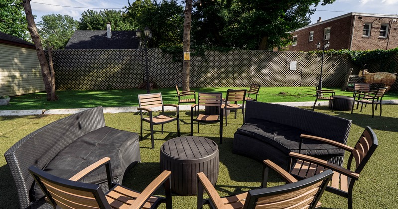 Outdoor lounge area with sofas, chairs, and tables