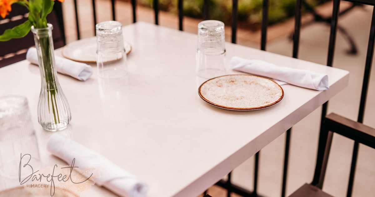 Patio table with tableware and flowers