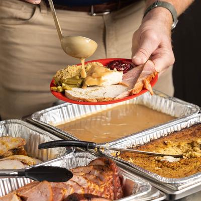 Pouring food into a plate.