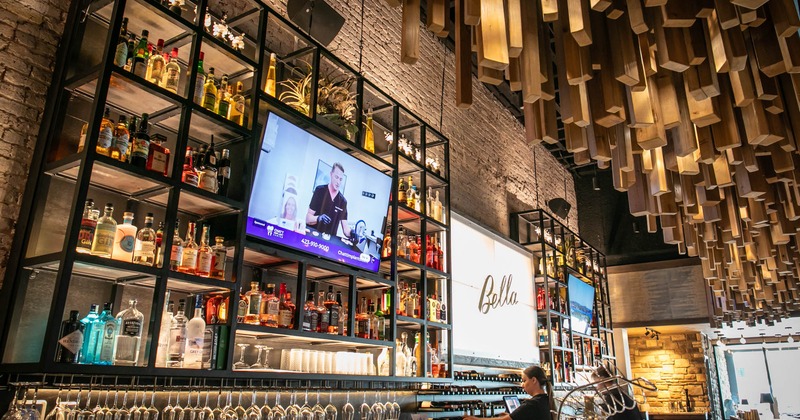 Interior, bar shelves filled with bottles of spirits