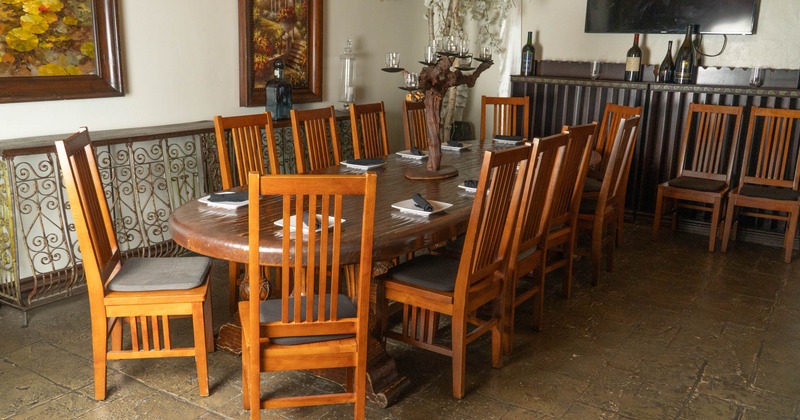 Interior, big wooden table with chairs ready for guests