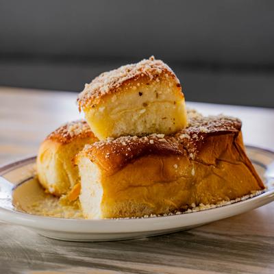 Warm potato rolls with butter, sea salt, garlic, and Parmesan.