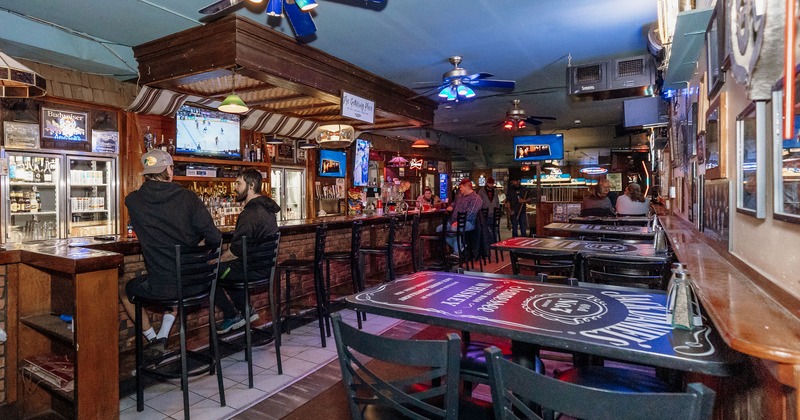 Interior, bar area on the left, and bar tables and stools on the other side