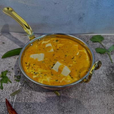 Soft paneer cubes cooked in a tangy yogurt-based curry with mild spices.