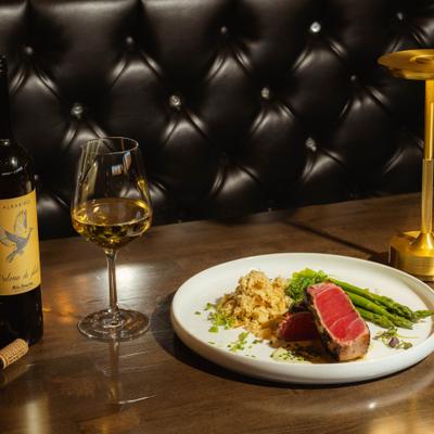 Wasabi crusted ahi tuna plate served with white wine.