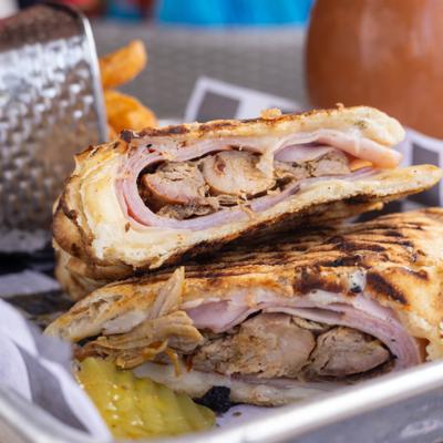 House-smoked pulled pork, ham, Swiss cheese, gold BBQ sauce, spicy pickles, panini style.