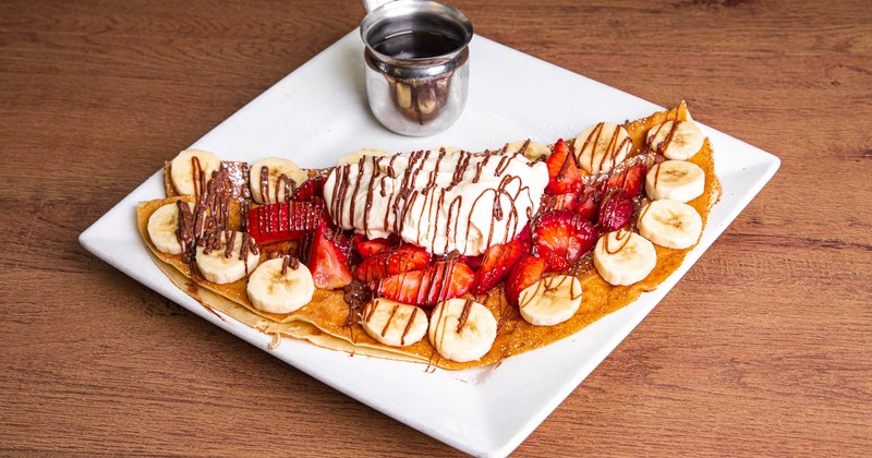 Banana and strawberry pancakes with chocolate drizzle