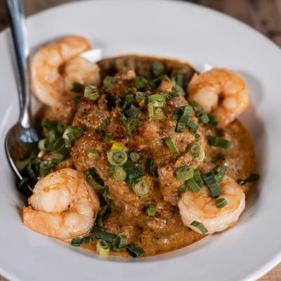 Crawfish etouffee topped with shrimp, close-up.