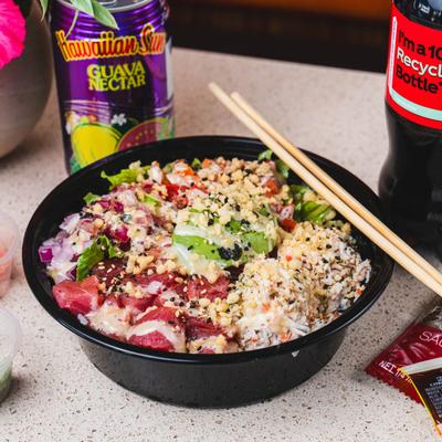 Tuna bowl, with lettuce, avocado, tomato, red onion, ponzu sauce, and sesame seeds.