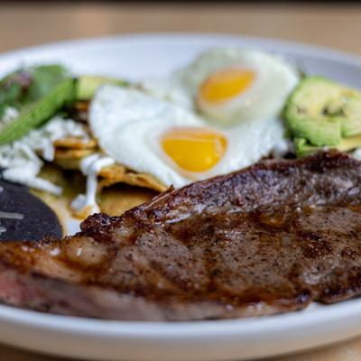 Plate of Steak and Eggs served with chilaquiles.