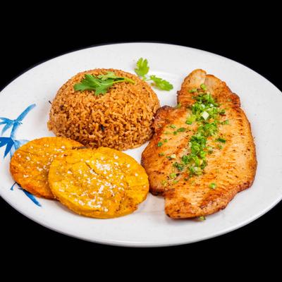 Grilled swai fish fillet with coconut rice and fried green plantains.