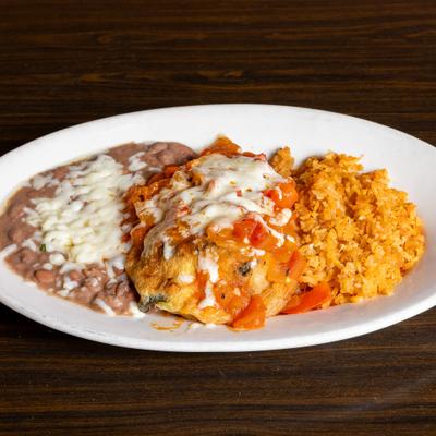 Stuffed chili pepper, served with rice and beans.