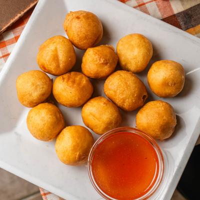 Sweet and Sour Chicken Balls served with a dipping sauce.