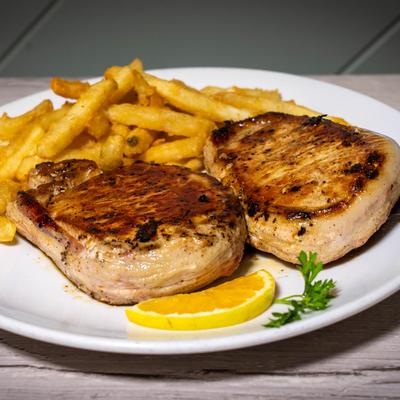 Grilled pork chops with fries.