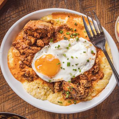 Cajun-fried chicken livers with grits, fried egg, and a fork