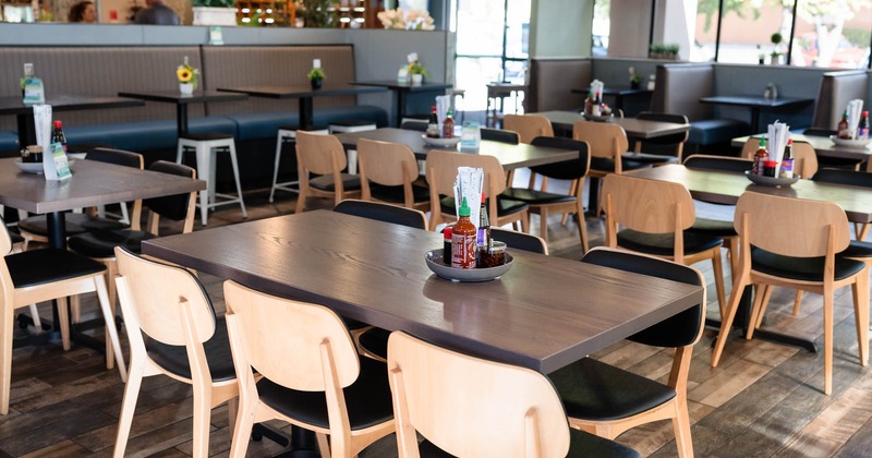 Interior, long wooden dining tables with chairs