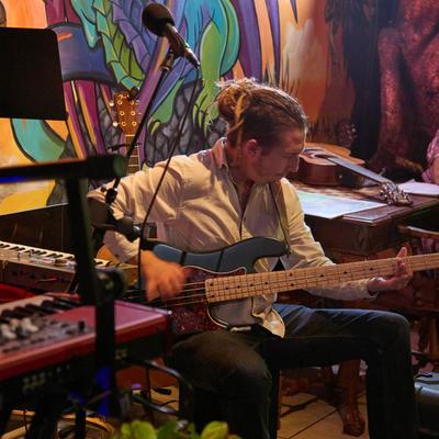 A person playing the bass guitar.