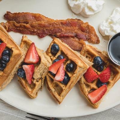 Waffle, strawberries, blueberries, bacon and sour cream