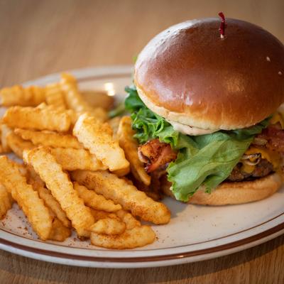 The OG Legendary Burger served with fries.