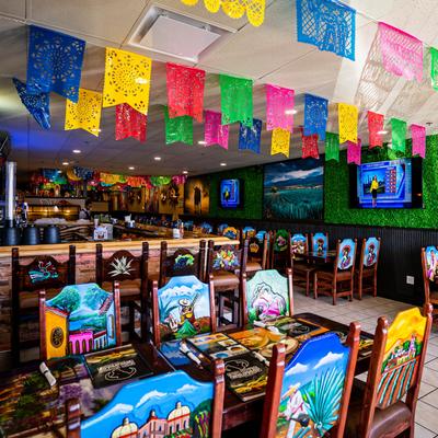 Interior, dining area, colorful chairs.