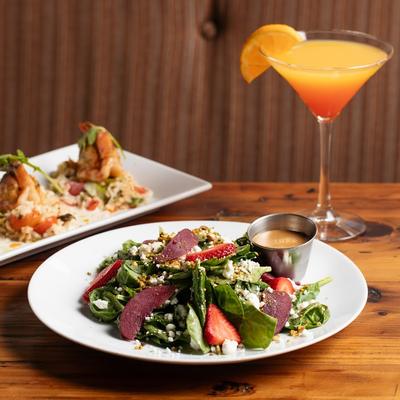 Strawberry and spinach salad paired with an orange.