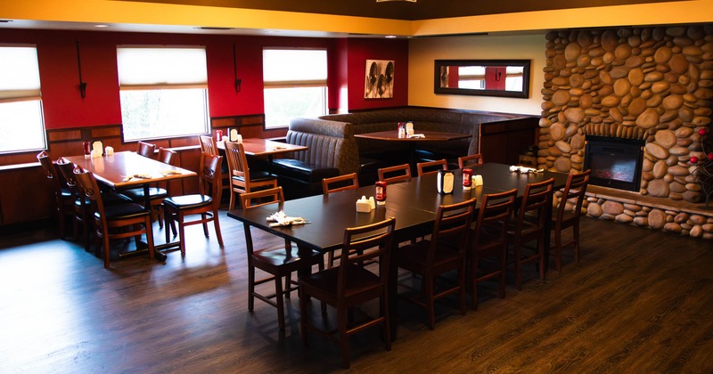 Seating tables and a restaurant booth in the corner