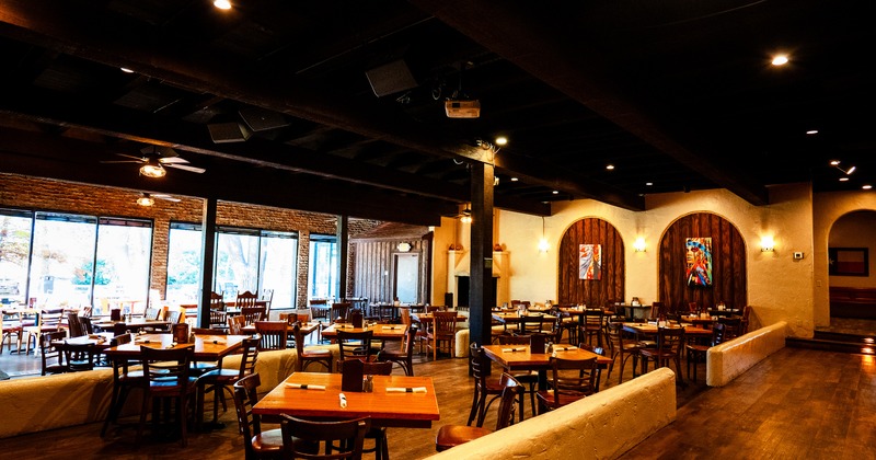 Spacious and warmly rustic-style interior dining area with set tables