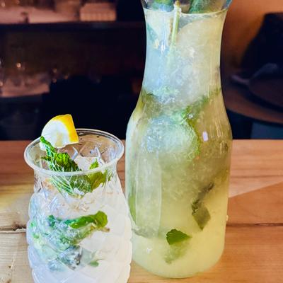 Ginger Mint Lemonade served in a pitcher with a pineapple-shaped glass.