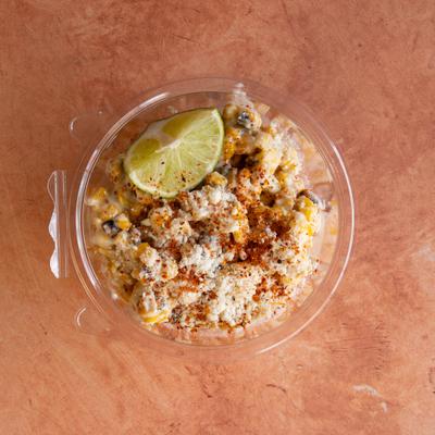 Mexican street corn snack, with mayo, Cotija cheese, and chili powder.
