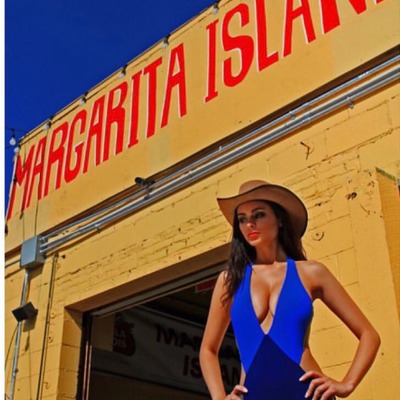 Restaurant exterior, one of guests posing for a photo.